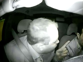 Still frame from dash cam video of a cab driver being verbally attacked by a passenger.