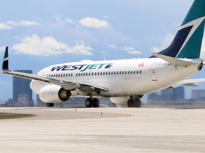A Westjet Boeing 737 taxis toward the Calgary International Airport's new $600-million runway on the first day of operations Saturday.