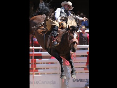 Robert Reynolds from Oakland, Iowa rides Yellow Houston in the novice bareback event during Day 1 of the Calgary Stampede rodeo on  Friday July 3, 2015.