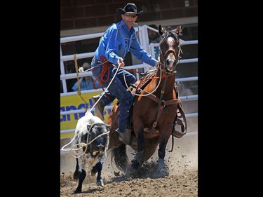 Alwin Bouchard from Scandia AB competes in the tie-down roping event during day 1 of the Calgary Stampede rodeo on  Friday July 3, 2015.