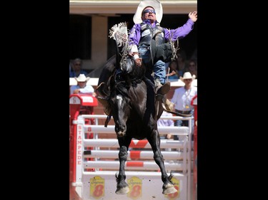 Dusty La Valley from Bezanson AB riding Black Moon competes in the bareback event during day 1 of the Calgary Stampede rodeo on  Friday July 3, 2015.