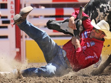 Bray Armes from Ponder Texas competes in the steer wrestling event during day 1 of the Calgary Stampede rodeo on  Friday July 3, 2015.