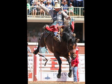 Cody Wright from Milford Utah riding Witless Margie competes in the saddle bronc event during day 1 of the Calgary Stampede rodeo on  Friday July 3, 2015.