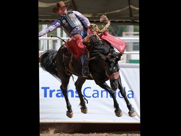 Sam Kelts from Millarville Alberta gets a re-ride while competing in the saddle bronc event during day 1 of the Calgary Stampede rodeo on  Friday July 3, 2015.