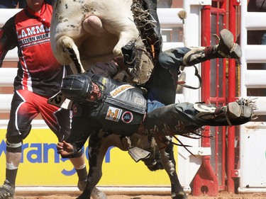 Chad Besplug from Claresholm Alberta rides Teen Spirit while competing in the bull riding event during day 1 of the Calgary Stampede rodeo on  Friday July 3, 2015.