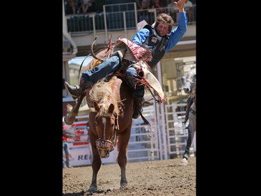 Luke Davie from Plattsmouth, Nebraska rides You're Just So in the novice bareback event during Day 1 of the Calgary Stampede rodeo on  Friday July 3, 2015.