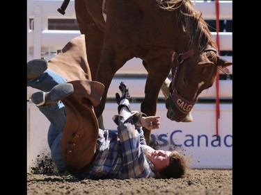 Brendon McCallum from Red Deer gets bucked off rides Yucatan Margie in the novice bareback event during Day 1 of the Calgary Stampede rodeo on  Friday July 3, 2015.