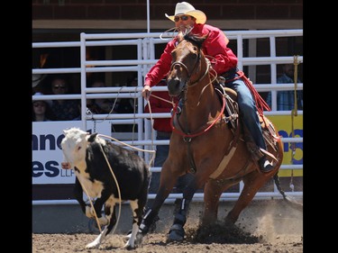 Randall Carlisle from Athens Louisiana competes in the tie-down roping event during day 1 of the Calgary Stampede rodeo on  Friday July 3, 2015.