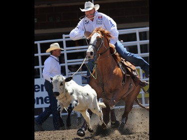 Curtis Cassidy from Donald AB competes in the tie-down roping event during day 1 of the Calgary Stampede rodeo on  Friday July 3, 2015.