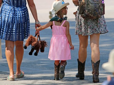 Calgary Stampede goers were dressing for the heat as they walked the midway on Thursday July 9, 2015.