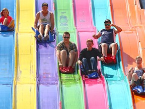 Calgary Stampede visitors zip down the Euroslide on the midway Thursday afternoon, Thursday, July 9.