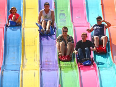 Calgary Stampede visitors zip down the Euroslide on the midway Thursday afternoon, Thursday July 9, 2015.