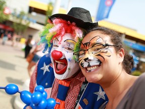 Doo Doo the Clown poses with fan Lisa Mason at the Calgary Stampede on July 10, 2015.