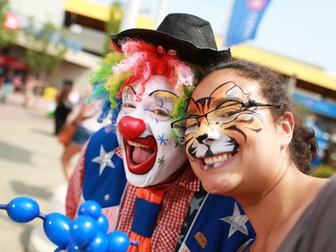 Doo Doo The Clown poses with fan Lisa Mason at the Calgary Stampede on July 10, 2015.