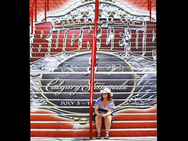 Natasha Koshowski waits for friends at the bottom of the brightly coloured stairs to the Saddledome at Stampede Park on Friday July 10, 2015.