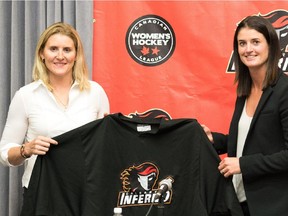 Hayley Wickenheiser, left, poses with Calgary Inferno assistant coach Gina Kingsbury at Tuesday's press conference. Regarded as the best women's hockey player of all time, Wickenheiser announced she is entering the Canadian Women's Hockey League draft next month with the intention of playing for the Inferno.