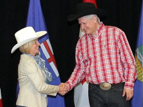 Premier Rachel Notley shakes hands with Prime Minster Stephen Harper before their meeting at the Harry Hays Building Monday, July 6, 2015.