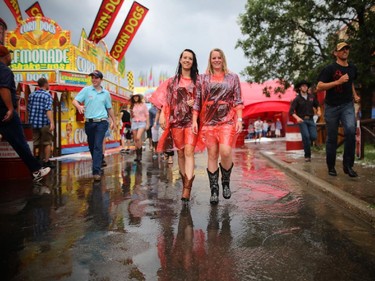 These ladies sported some new Stampede fashion when the rain and hail hit the Calgary Stampede grounds on july 4, 2015.