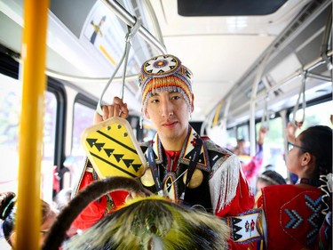 Chris Kawuitts from Stoney Nakoda rides a bus with fellow dancers from Indain Village to perform at Olympic Plaza in Calgary on July 6, 2015. This year marks the last that Indian Village will be in it's current location at the Stampede.