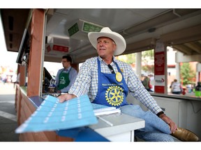 Ron Baas, a volunteer with the Rotary Club of Calgary, sells tickets for the Rotary Dream Home draw at the Calgary Stampede grounds on July 7, 2015.