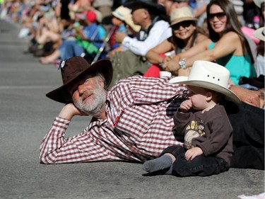 Doug Osborne and his grandson Aiden Walters, 14 months, enjoy the Calgary Stampede parade on July 3, 2015.