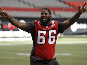 Former Calgary Stampeders offensive linesman Stanley Bryant (66) celebrates a bocce ball game win during the West Division Champions Walkthrough held at BC Place in Vancouver, B.C., on Saturday, Nov. 29, 2014.