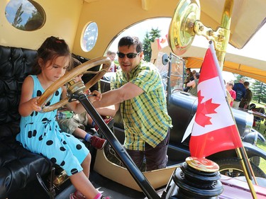 Sofia Patino, 4, checks out a 1914 Model T with her brother and dad during Canada Day at Heritage Park.