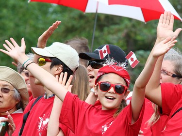 Rachel Kobayakawa, 11,  laughs as she dances with other Calgarians as they form a living Canadian flag on Prince's Island on Canada Day 2015.