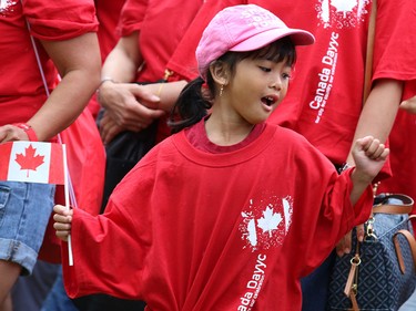 Calgarians dance as they form a living Canadian flag on Prince's Island on Canada Day 2015.