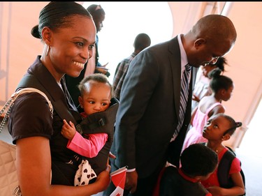 The Olabiyi family gathers together after receiving their Canadian citizenship in a Canada Day ceremony at Heritage Park.