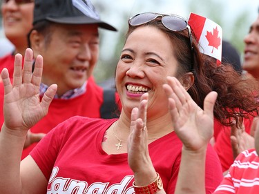 Myrna Danglapen laughs as she dances with other Calgarians as they form a living Canadian flag on Prince's Island on Canada Day 2015.