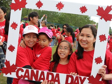 The Eusebio family poses in a patriotic picture frame on Prince's Island on Canada Day 2015.