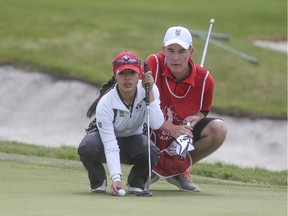 Jaclyn Lee and caddie Daniel Ludwick line up a putt during the Canadian Women's Tour event at the Glencoe G&CC in May. Lee is out to defend her Sun Life Financial Alberta Ladies Amateur title this week at Lynx Ridge GC in Calgary.