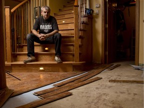 Predrag Ljalievic stands in his flood damaged basement in his home in Chestermere on Tuesday, July 14, 2015. Several inches of flood water destroyed the hardwood floor, furniture, and many personal items belonging to him and Sasa Boric.