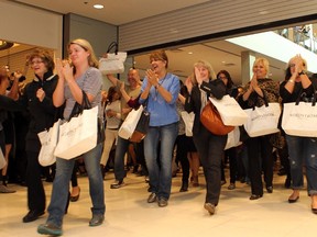 The first customers come through the doors as over 1000 customers were lined up for the grand opening of the Nordstrom store in Chinook Centre on September 19, 2014.