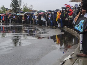 A large crowd of commuters waits for shuttle buses at Chinook station, after an outage halted service north of the station into downtown Calgary.