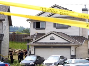 Calgary police investigate a home where two people were found dead in Calgary's N.W. community of Valley Ridge, on July 11 2015.