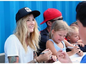 BMX rider Angie Marino signs autographs after performing at the Bell Adrenaline Ranch at the Calgary Stampede on July 3, 2015.