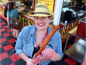 Gwendolyn Richards has some fun with the biggest dog on a stick at the Calgary Stampede, while she ate her way across the midway.