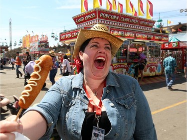 Gwendolyn Richards tries the lobster corndog for a great twist at the Calgary Stampede in Calgary, on July 6, 2015.