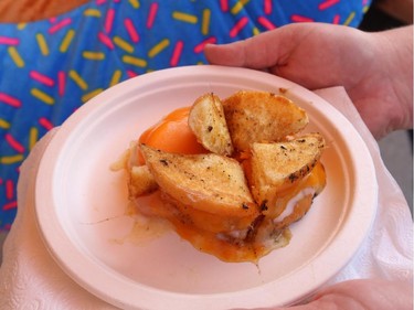 Gwendolyn Richards tries the glazed donut grilled cheese, which was a no go, at the Calgary Stampede in Calgary, on July 6, 2015.