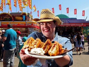 Gwendolyn Richards tries the Kabob from the Peanut Butter Cupboard for a lovely delight at the Calgary Stampede in Calgary, on July 6, 2015.