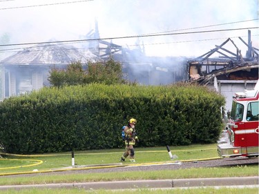 A northwest Calgary house goes up in flames as firefighters react defensively to control the blaze, on July 20, 2015.