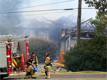 A northwest Calgary house goes up in flames as firefighters react defensively to control the blaze, on July 20, 2015.