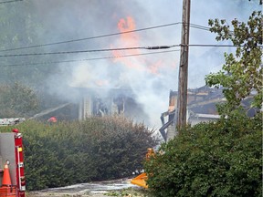 A northwest Calgary house goes up in flames as firefighters react defensively to control the blaze, on July 20, 2015.