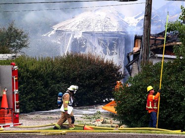 A Calgary NW house went up in flame as firefighters react defensively to control the blaze, on July 20, 2015.