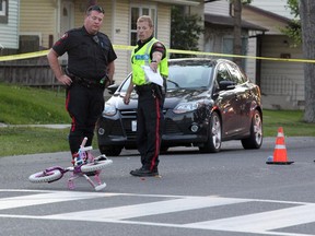 Members of the Calgary Police Service were on the scene investigating after a woman and two children struck while crossing Temple Drive at 56th Street NE just after 8 pm on July 29, 2015.