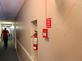 A resident walks down the hall past one of the swastikas and racist sayings that have been written on the hallway walls of the apartment block at 1419 17th Ave NW. They were photographed on July 31, 2015.