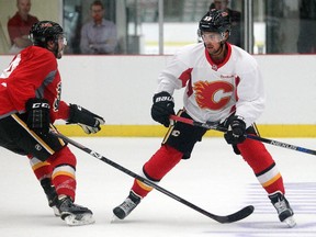 Defenceman Oliver Kylington, right, patrols the blue line during the Calgary Flames' prospect camp scrimmage on Thursday at WinSport Arenas.