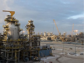Imperial Oil reported better reliability at its initial Kearl oilsands facility at left and a faster than expected ramp up at the expansion project under construction at right in this file picture.